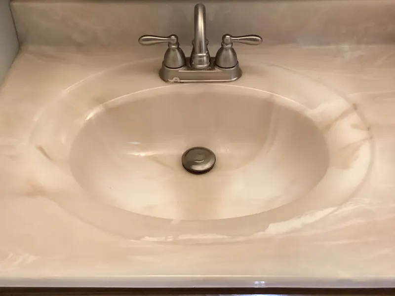 Bathroom sink with an old brushed-nickel two-handle faucet
